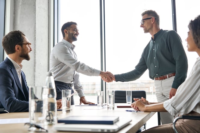 CFO shaking hands with new Employer of Record partner.