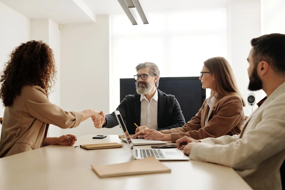 Business meeting between CEO and CFO discussing what's right for their business, a PEO or EOR.