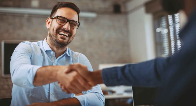 CEO shaking hands during a mergers and acquisition deal.