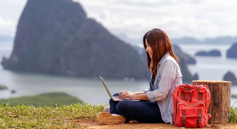 Woman working remote in a foreign country, using her work laptop.